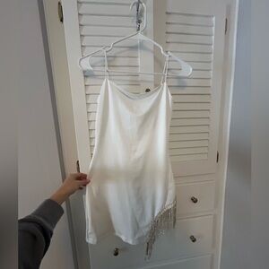 White fitted dress with dangling sequins on the side
